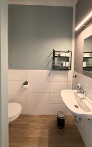 a white bathroom with a sink and a toilet at JOSEFS Gasthaus Sibille in Schlangen +19 photos