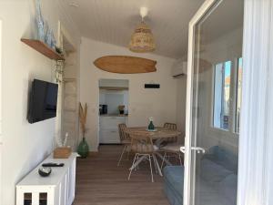 a living room with a table and a dining room at Andernos les pieds dans l eau in Andernos-les-Bains