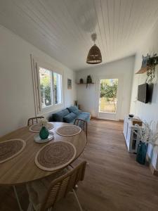 a living room with a table and a blue couch at Andernos les pieds dans l eau in Andernos-les-Bains +16 photos