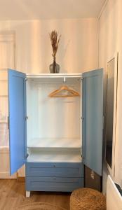 a blue cabinet with a hanger in a room at Andernos les pieds dans l eau in Andernos-les-Bains