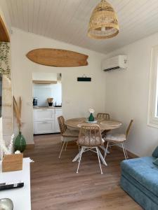 a living room with a table and chairs at Andernos les pieds dans l eau in Andernos-les-Bains