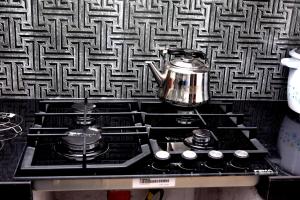 a stove top with a tea kettle on top of it at AERO View Villa in Induruwa
