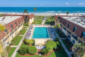 an aerial view of a resort with a swimming pool and the beach at Condo By The Sea! in Cocoa Beach