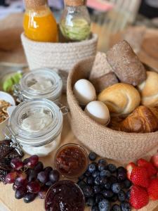 a table topped with baskets of food and fruit at BLUSH Bed and Breakfast in Sprundel +10 photos