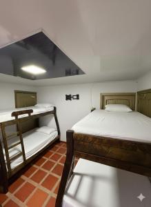 two bunk beds in a room with a roof at Rancho Akila in Filandia +40 photos