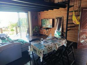 a room with a table and chairs in a room at Casa da Lagoa perto do Mar in Pescaria Brava