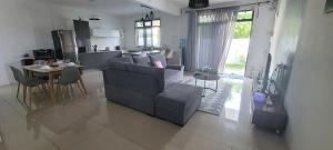 a living room and kitchen with a couch and a table at Crater Serenity Studio in Curepipe +14 photos