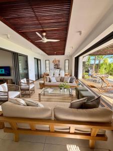 a living room with couches and a table at Coral Villa in Cap Malheureux