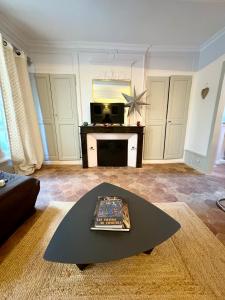 a living room with a couch and a table at Studio parvis Cloitre Notre Dame in Chartres