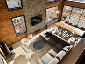 an overhead view of a living room with a couch and a table at Chalet 1480 in Allos