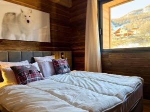 a bedroom with two beds and a window at Chalet 1480 in Allos +33 photos