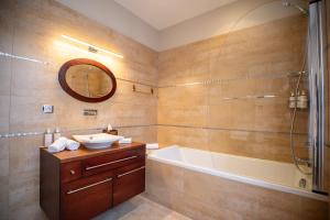 a bathroom with a tub and a sink and a shower at Villa Ker Betsy in Dinard +30 photos