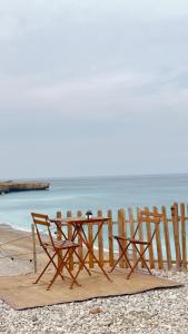 a picnic table and chairs on the beach at Happy dreams in Ramlah