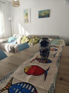 ein Tisch mit einer Vase darauf in der Unterkunft SeaSuites Blue-Ático con terraza chillout cerca del mar en Cullera in Mareny de San Lorenzo