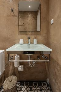 a bathroom with a sink and a mirror at Ermou Residences in Volos