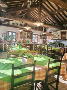 a dining room with green tables and chairs at Agriturismo Terra Sabina in Poggio Mirteto