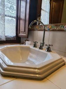 a white sink with a faucet in a bathroom at Agriturismo Terra Sabina in Poggio Mirteto +99 photos