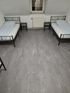 a room with three beds and a tile floor at modernes & einfaches übernachten in Bruchsal +25 photos