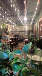 a group of people sitting at tables in a restaurant at Nilowin Glenanore Guesthouse in Haputale