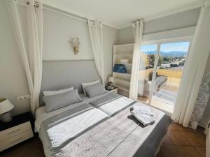 a bedroom with a large bed and a large window at La Vida Bonita in El Verger