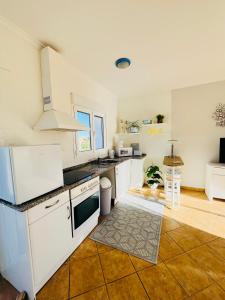 a kitchen with white counters and white appliances at La Vida Bonita in El Verger