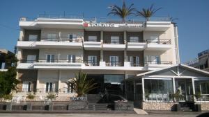 a white building with palm trees on top of it at Tokalis Boutique Hotel & Spa in Nea Anchialos