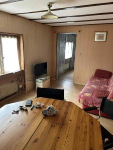 a room with a wooden table and a bed at maison indépendante in Millery
