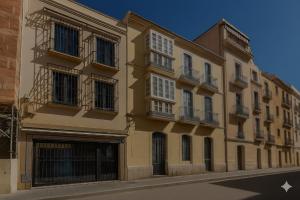 a yellow building on a city street at AYZ Frailes - Auto check-in property in Málaga