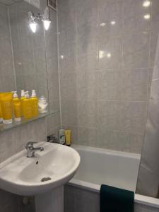 a bathroom with a sink and a bath tub at Zakątek in Warsaw