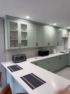 a kitchen with white cabinets and a white counter top at Dalleos Getaway in Tacarigua