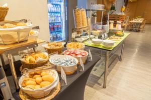 a buffet of food on a table in a store at GHL Hotel Neiva in Neiva