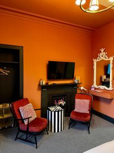 a living room with two chairs and a fireplace at The Pines Guest House in Elgin +33 photos
