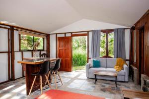 a living room with a couch and a table at Casa Cúrcuma in Turrialba