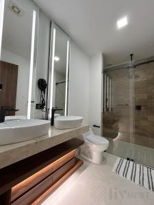 a bathroom with two sinks and a toilet and a shower at Quiet Room w/bath + Top Amenities! in La Cañada