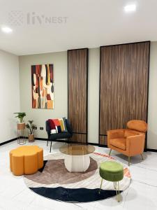 a living room with orange chairs and a coffee table at Quiet Room w/bath + Top Amenities! in La Cañada