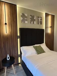 a bedroom with a bed with a black headboard and a table at Quiet Room w/bath + Top Amenities! in La Cañada +57 photos