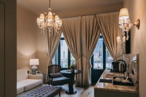 a living room with a couch and a chandelier at Torel Palace Porto in Porto