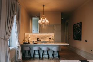 a kitchen with a large island with stools around it at Torel Palace Porto in Porto +103 photos