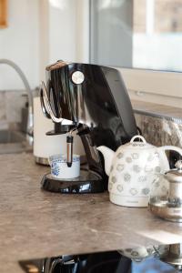 a coffee maker and a tea kettle on a counter at Vilka u Dyje in Znojmo