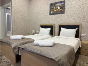 two beds in a room with two beds sidx sidx sidx sidx at Aquapark Quba Hotel in Quba