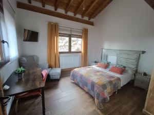 a bedroom with a bed and a table and a window at MIRADOR DEL HITO I y MIRADOR DEL HITO II in Espinosa de Bricia +51 photos