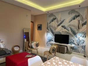 a living room with a tv on a wall at Pompei Home Apartament in Boscoreale