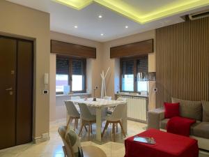 a living room with a table and a couch at Pompei Home Apartament in Boscoreale