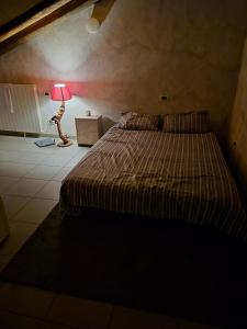 a bedroom with a bed and a lamp in a room at Julias house in Biella