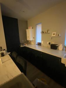 a kitchen with a counter and a table and a window at Big Town Charm in Drogheda