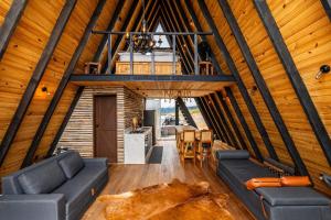 a room with a couch and a table in a cabin at Canda Cabana com SPA e vista para Cachoeiras in Baependi
