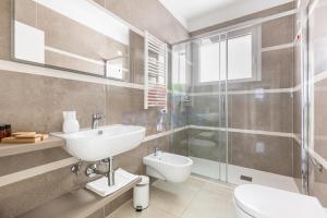 a bathroom with a sink and a toilet and a shower at Residence Stella del Mare in Torre Pali