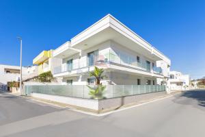 a large white building on the side of a street at Residence Stella del Mare in Torre Pali