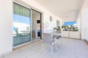 a view of the living room with a table and chairs at Residence Stella del Mare in Torre Pali