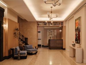 a hallway with a living room with a couch and chairs at Mint House Washington Dc Downtown By Kasa in Washington, D.C.